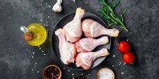 raw-chicken-legs-with-spices-stone-background