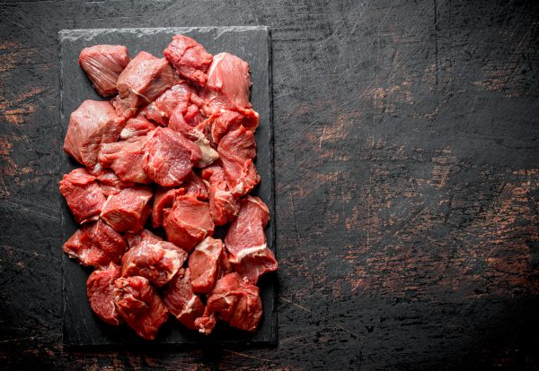 Sliced raw beef on a stone Board.